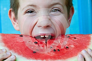 Portrait of a child who eats a watermelon slice