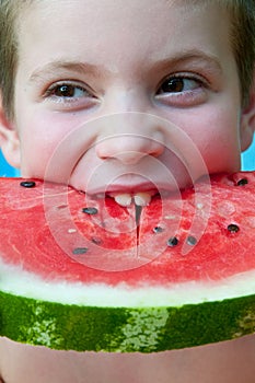 Portrait of a child who eats a watermelon slice