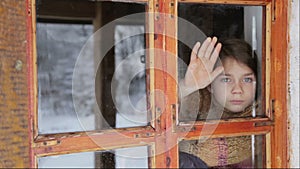 Portrait of child in the window. The boy face close up child through the glass.