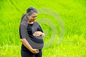 Portrait of childbearing woman on rural fields landscape