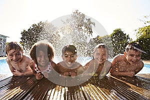 Portrait Of Children Having Fun In Outdoor Swimming Pool photo