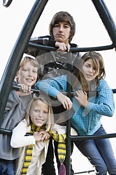 Portrait of children on playground equipment