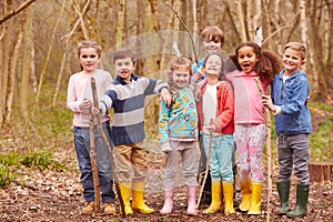 Portrait Of Children Playing Adventure Game In Forest