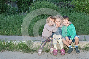 Portrait of children sitting on the curb