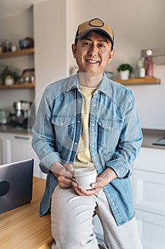 Portrait of a chinese man drinking coffee at home