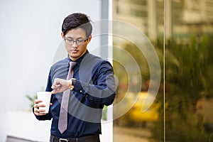 Portrait of chinese office worker checking time watch