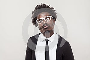 Portrait choke man in white glasses grimacing at camera.