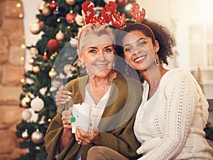 Portrait, christmas and blended family with a woman and daughter in law together in a home during the festive season