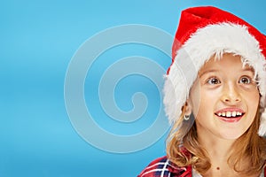Portrait of Christmas little Girl in Santa Hat, smiling