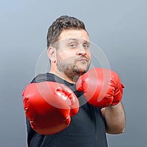 Portrait of chubby boxer posing with boxing gloves