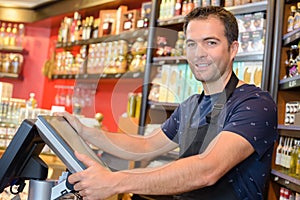 Portrait clerk stood by electronic cash register photo