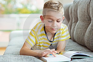 Portrait of clever little boy with reading book