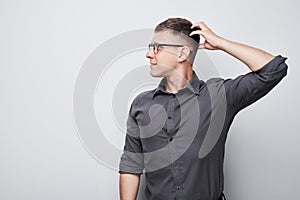 Portrait of clever man in shirt touching head thinks doubts chooses isolated on white studio background