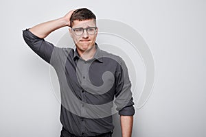 Portrait of clever man in shirt touching head thinks doubts chooses isolated on white studio background