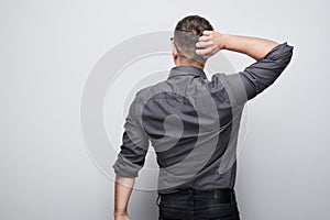 Portrait of clever man in shirt touching head thinks doubts chooses isolated on white studio background with copy space