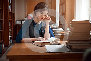 Portrait of clever student in university library.