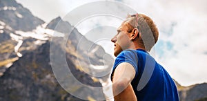 Portrait climber man looks on the mountain peaks