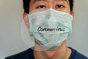 Portrait close-up of Asian man wearing a protective face mask against contagious disease and coronavirus.