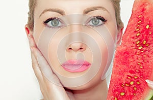 Portrait. Close-up of a beautiful young woman with a water-melon. The concept of healthy and moisturized skin. With Beautiful eyes