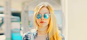 Portrait close up of blonde young teenager girl posing outdoors