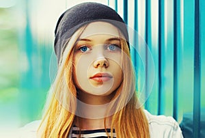 Portrait close up of blonde young teenager girl posing outdoors