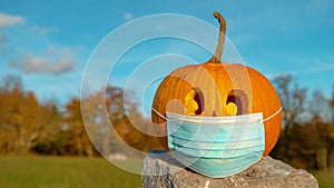 CLOSE UP, COPY SPACE Carved Halloween pumpkin wearing face mask covid protection