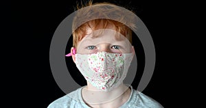 Portrait close up of little red hair boy wearing face mask during coronavirus pandemic blue eyes aryan