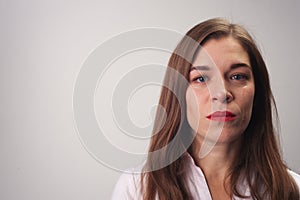 Portrait close-up of sad upset woman smiling sadly