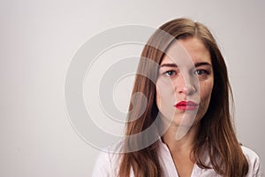 Portrait close-up of sad upset woman smiling sadly