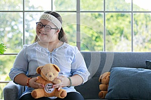 Portrait close up shot of Asian young happy chubby down syndrome autistic autism girl model wearing eyeglasses white knitted