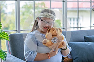 Portrait close up shot of Asian young happy chubby down syndrome autistic autism girl model wearing eyeglasses white knitted