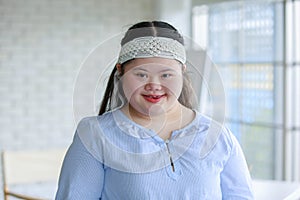 Portrait close up shot of Asian young happy chubby down syndrome autistic autism girl model wearing white knitted headband