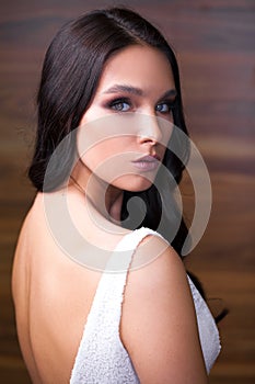 Portrait close up of young beautiful brunette woman in black dress