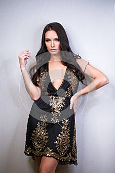 Portrait close up of young beautiful brunette woman in black dress