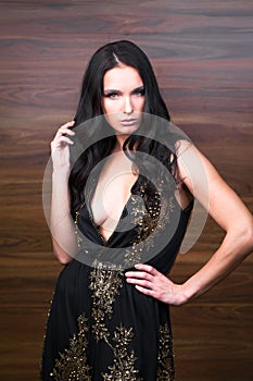 Portrait close up of young beautiful brunette woman in black dress