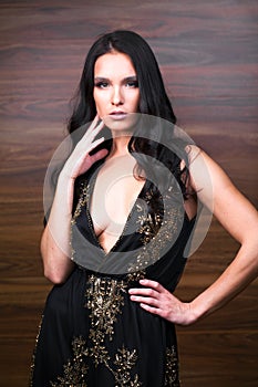 Portrait close up of young beautiful brunette woman in black dress