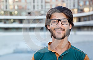 Portrait close up of a young muslim man with glasses.