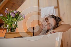 Portrait closeup of beautiful naked woman with closed eyes relaxing and spending weekend at home, soft focus. Taking