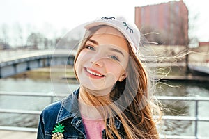 Portrait closeup beautiful young girl in city.