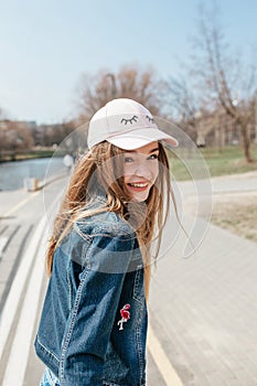 Portrait closeup beautiful young girl in city. Smiling girl in hat