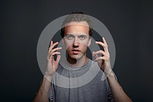 Portrait closeup funny confused skeptical man thinking looking in camera isolated on gray wall background with copy