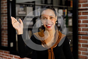 Portrait closeup shot of African American professional successful female businesswoman secretary in casual outfit standing smiling