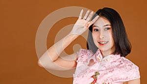 Portrait closeup studio shot millennial Asian female model in pink Chinese cheongsam qipao traditional peacock & flowers pattern