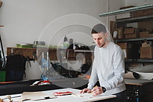 Portrait of a clothing designer or engineer at a generic workshop.