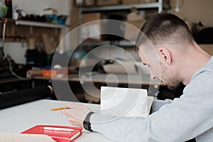 Portrait of a clothing designer or engineer at a generic workshop.