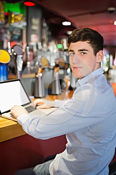 Portrait of cnfident man using laptop