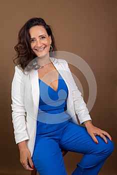 Portrait of coaching woman, sitting, looking at camera. Confidence, encouragement and motivation concept