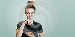 Portrait of cocky teenager girl with long ponytail hair on studio background, young woman with character, fashion model, female