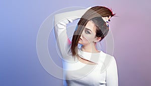 Portrait of cocky teenager girl with long ponytail hair on studio background, young woman with character, fashion model, female