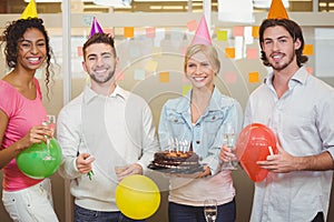 Portrait of colleagues enjoying birthday party